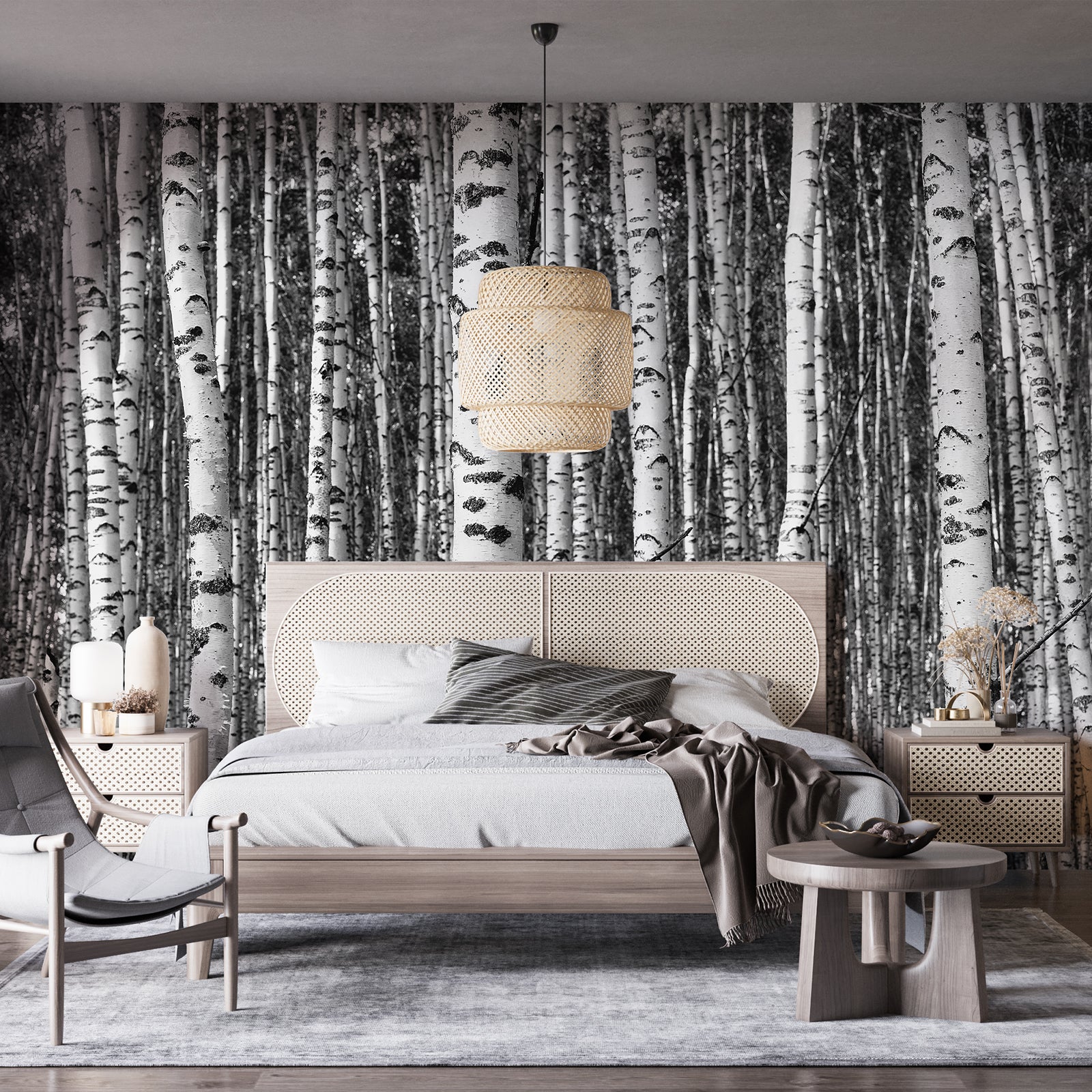 Black and white birch tree wall mural behind a modern minimalist bed